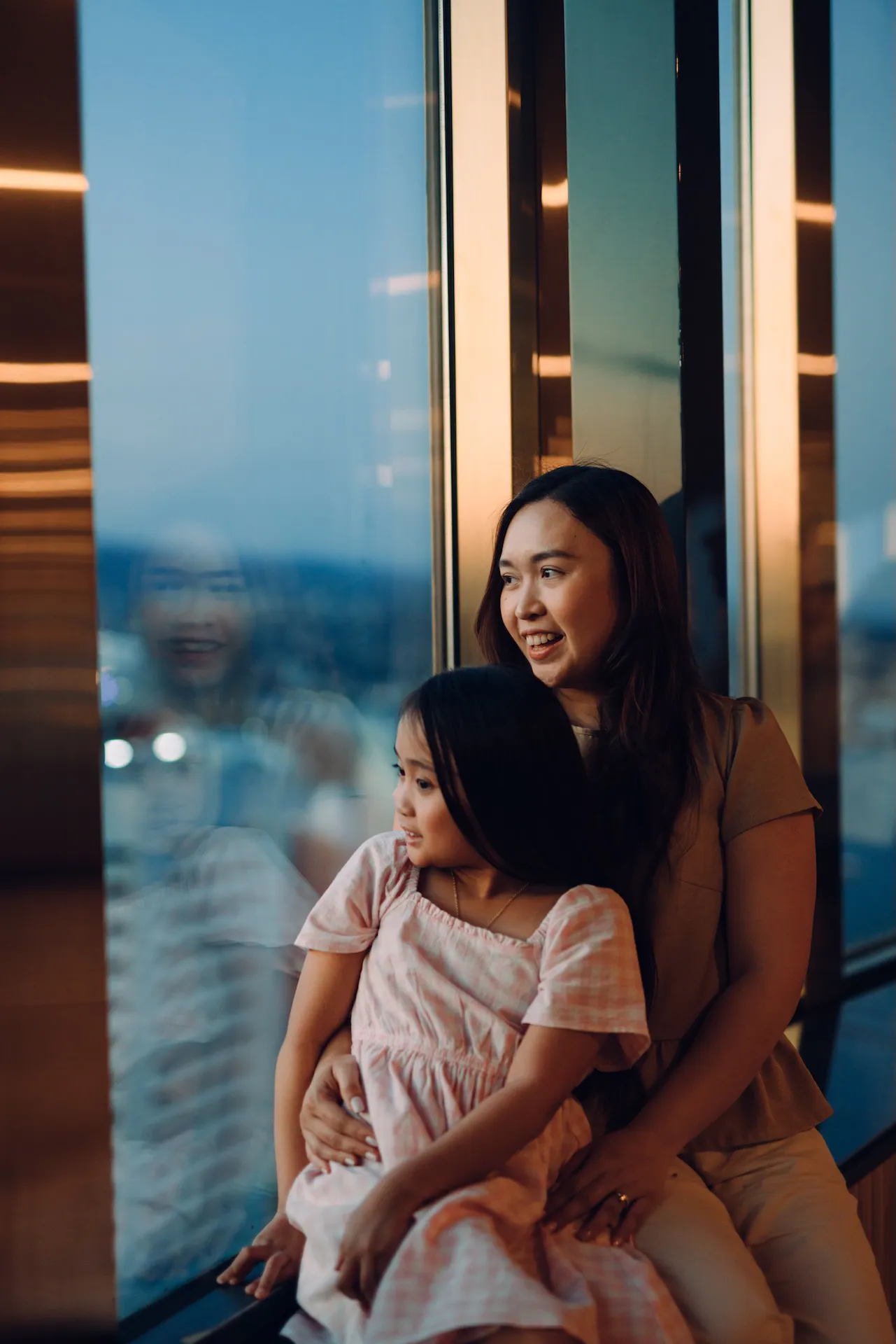 Girl and daught at observation deck window