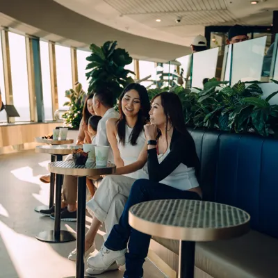 Two friends sitting at the cafe on the observation deck